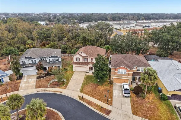 an aerial view of a house with a yard