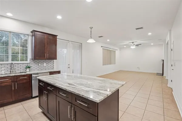 a kitchen that has a sink and a stove in it