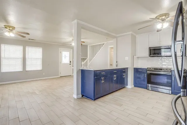 a kitchen with stainless steel appliances granite countertop a stove a sink and a refrigerator