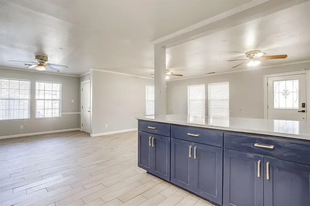 a spacious bathroom with a granite countertop double vanity and a mirror