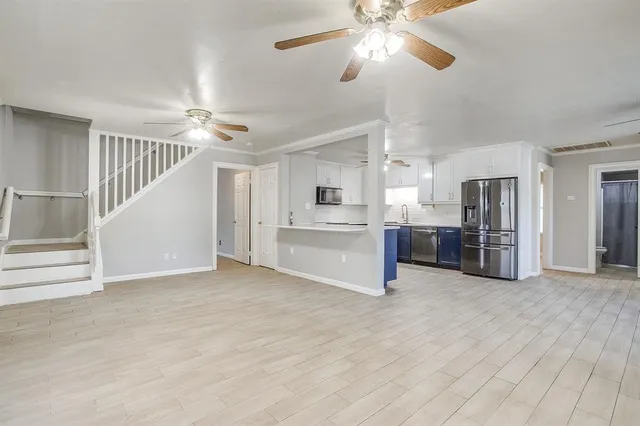 a view of a kitchen with a sink cabinets and entryway