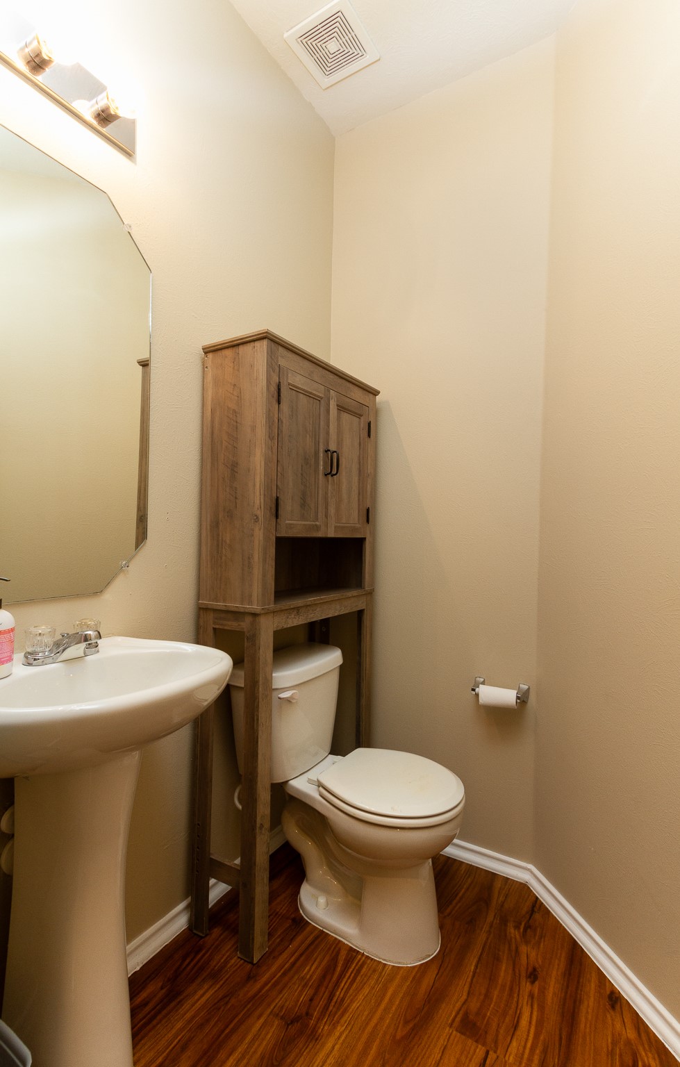 1107 Arum Road Missouri City, TX 77489 - Photo 20 of 23 The downstairs half bath is conveniently located off the family room and features a pedestal sink & recent laminate flooring.