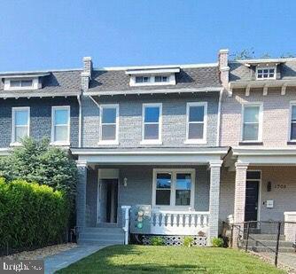 1706 Massachusetts Avenue Southeast, Unit A Washington, DC 20003 - Photo 1 of 9 a front view of a house with a garden
