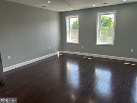 1706 Massachusetts Avenue Southeast, Unit A Washington, DC 20003 - Photo 3 of 9 an empty room with wooden floor and windows