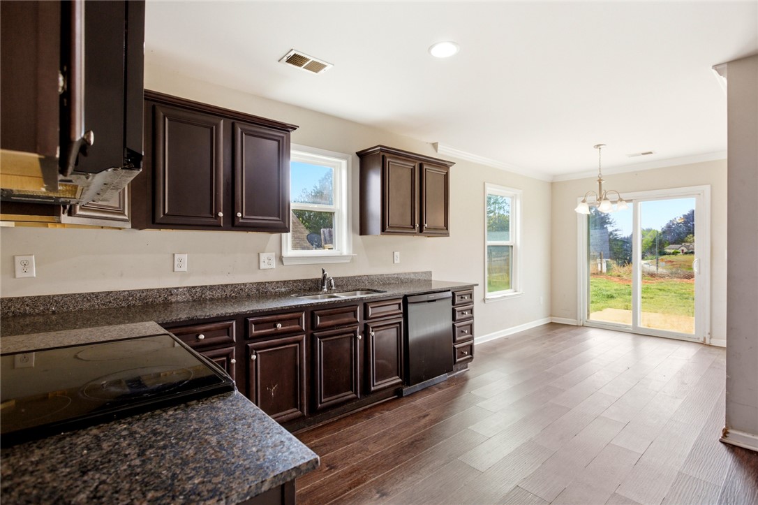 245 Maple Grove Road Seneca, SC 29678 - Photo 11 of 40 This spacious kitchen offers a seamless flow to the outdoors with rich cabinetry and ample counter space.