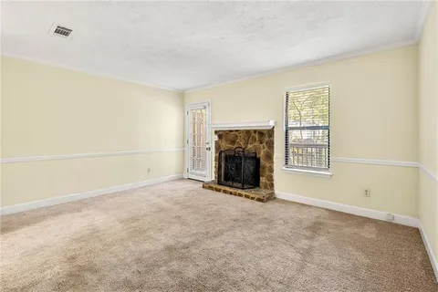 an empty room with a fireplace and a window