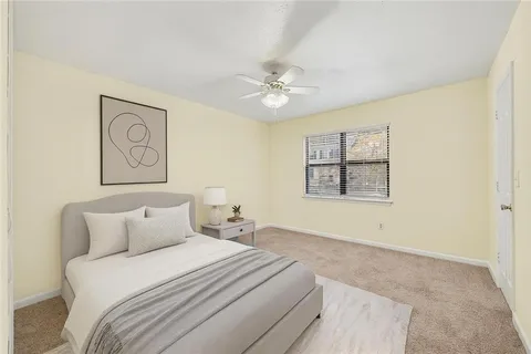 an empty room with windows and ceiling fan