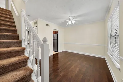 a view of entryway and hall with wooden floor