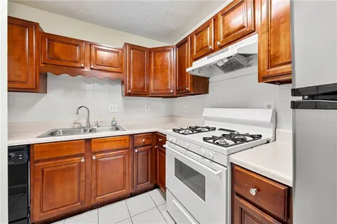 a kitchen with stainless steel appliances granite countertop a stove and a sink