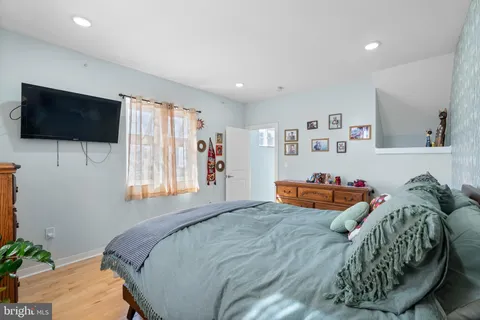 a bedroom with furniture and a flat screen tv