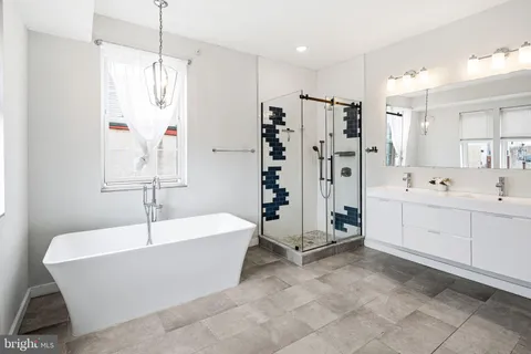 a bathroom with a bathtub and a shower