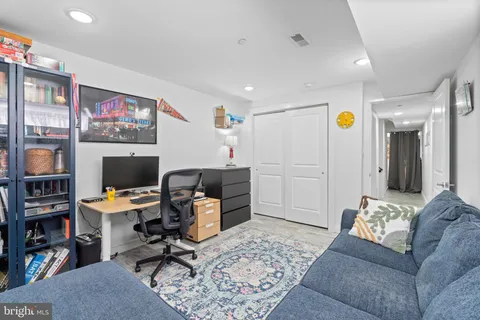 a workspace with furniture and ceiling fan