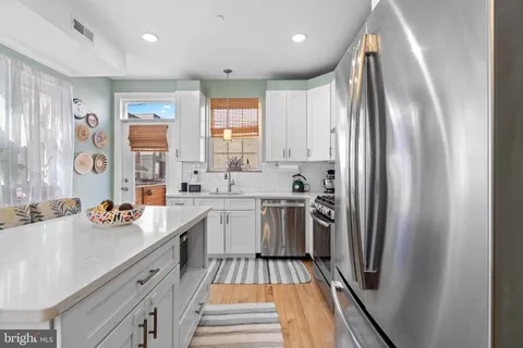 a kitchen with stainless steel appliances a sink stove and refrigerator