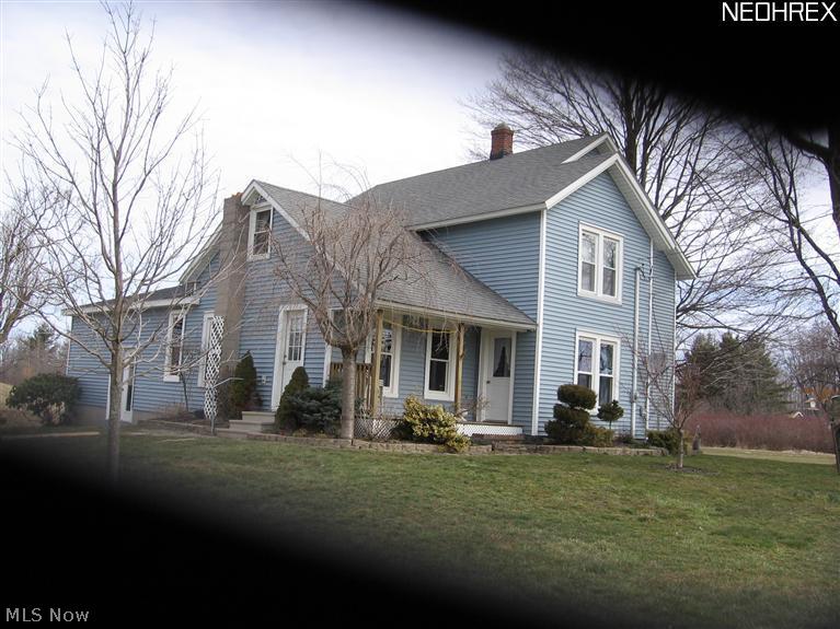 3103 East Maple Road Jefferson, OH 44047 - Photo 2 of 15 Southwest corner of home. Notice front porch with man door. side entrance, new double doors.
