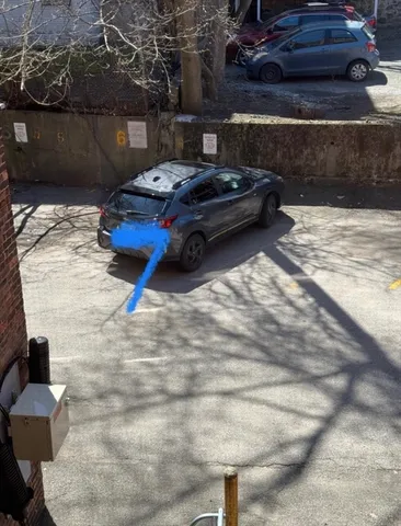 a car parked in parking lot of a house