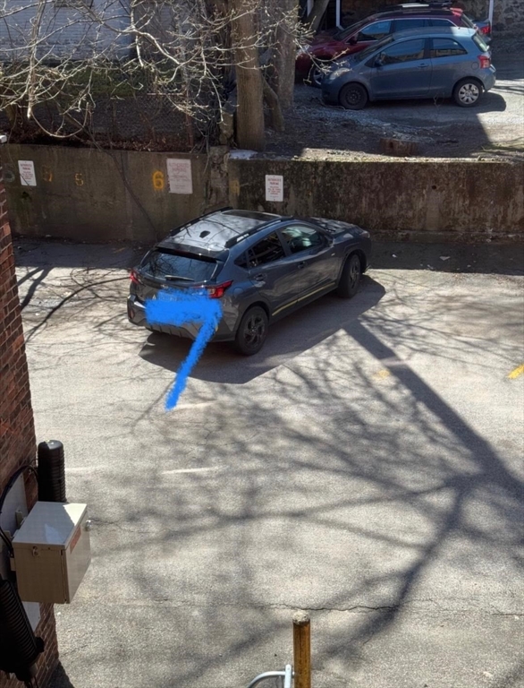 a car parked in parking lot of a house