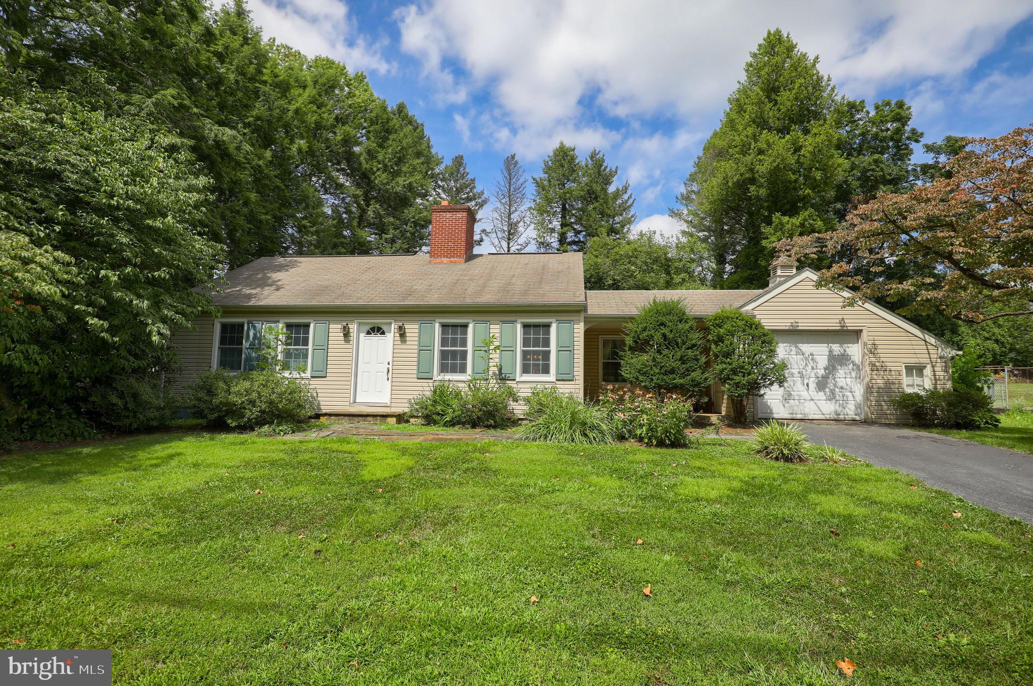 1565 Eden Road Lancaster, PA 17601 - Photo 1 of 33 a view of a house next to a big yard and large trees