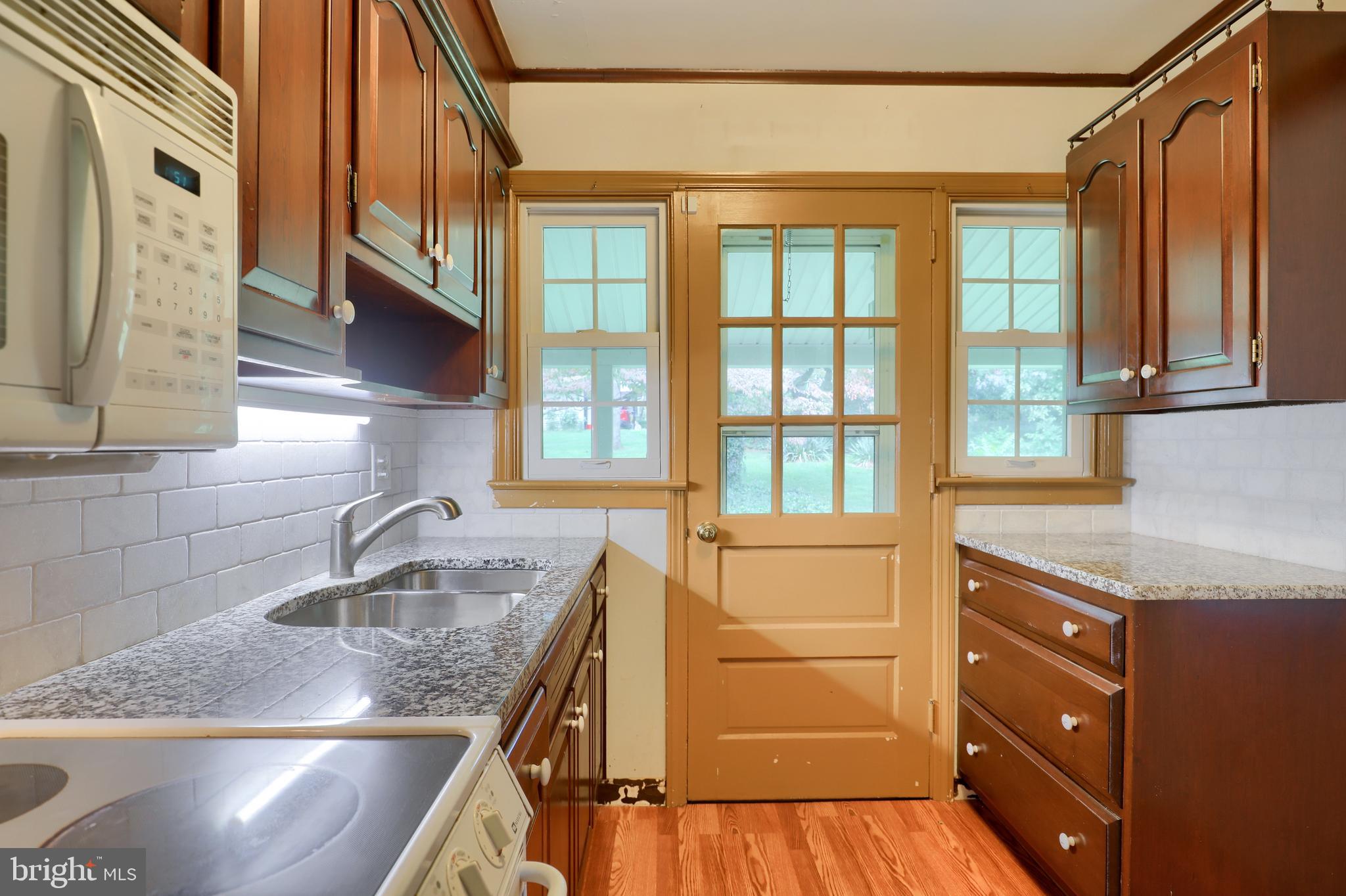 1565 Eden Road Lancaster, PA 17601 - Photo 17 of 33 a kitchen with stainless steel appliances granite countertop a sink and a large window
