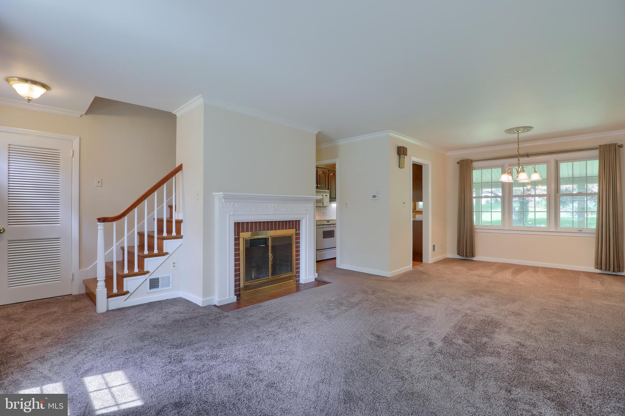 1565 Eden Road Lancaster, PA 17601 - Photo 4 of 33 a view of an empty room with fireplace and stairs