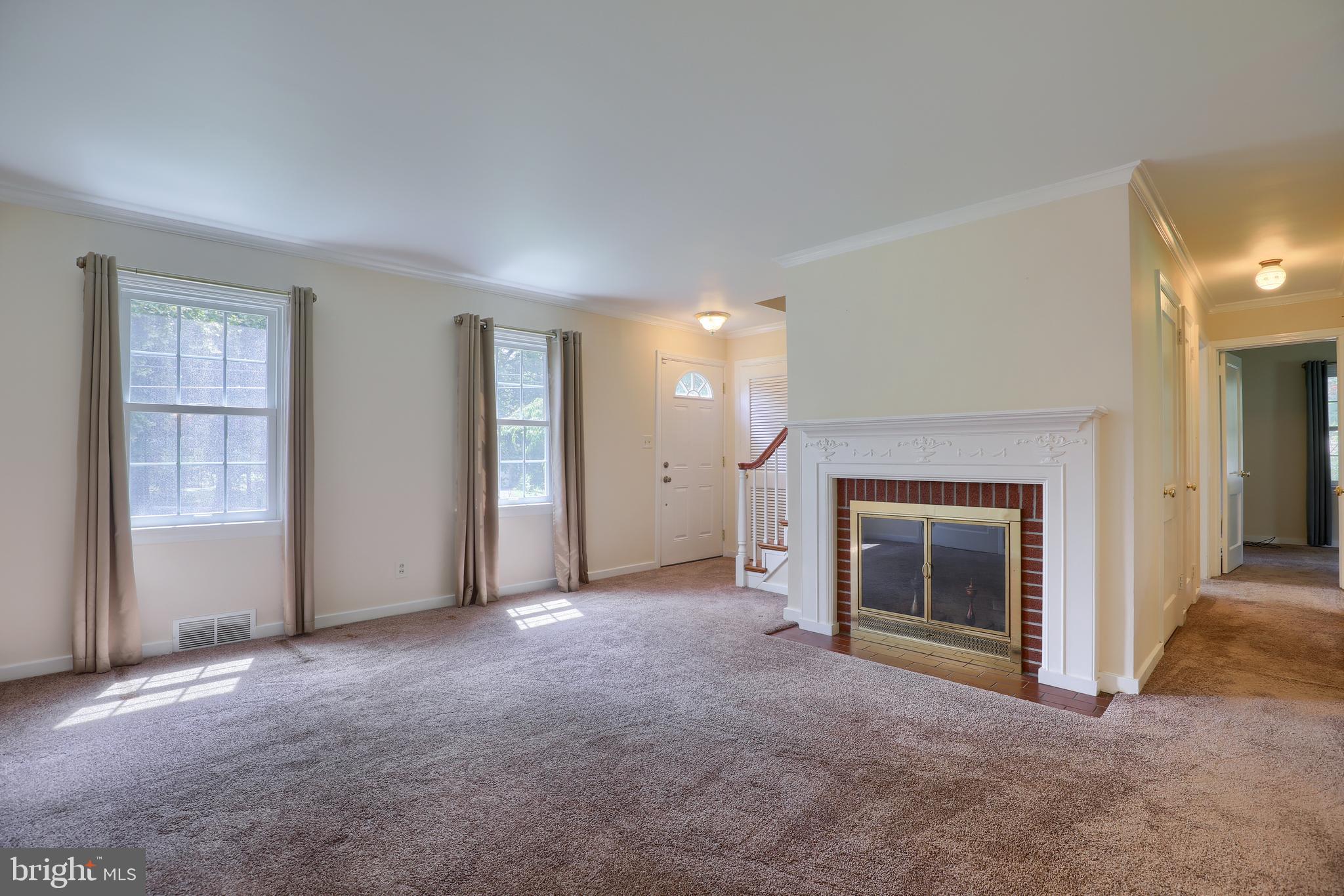 1565 Eden Road Lancaster, PA 17601 - Photo 7 of 33 an empty room with furniture and a fireplace