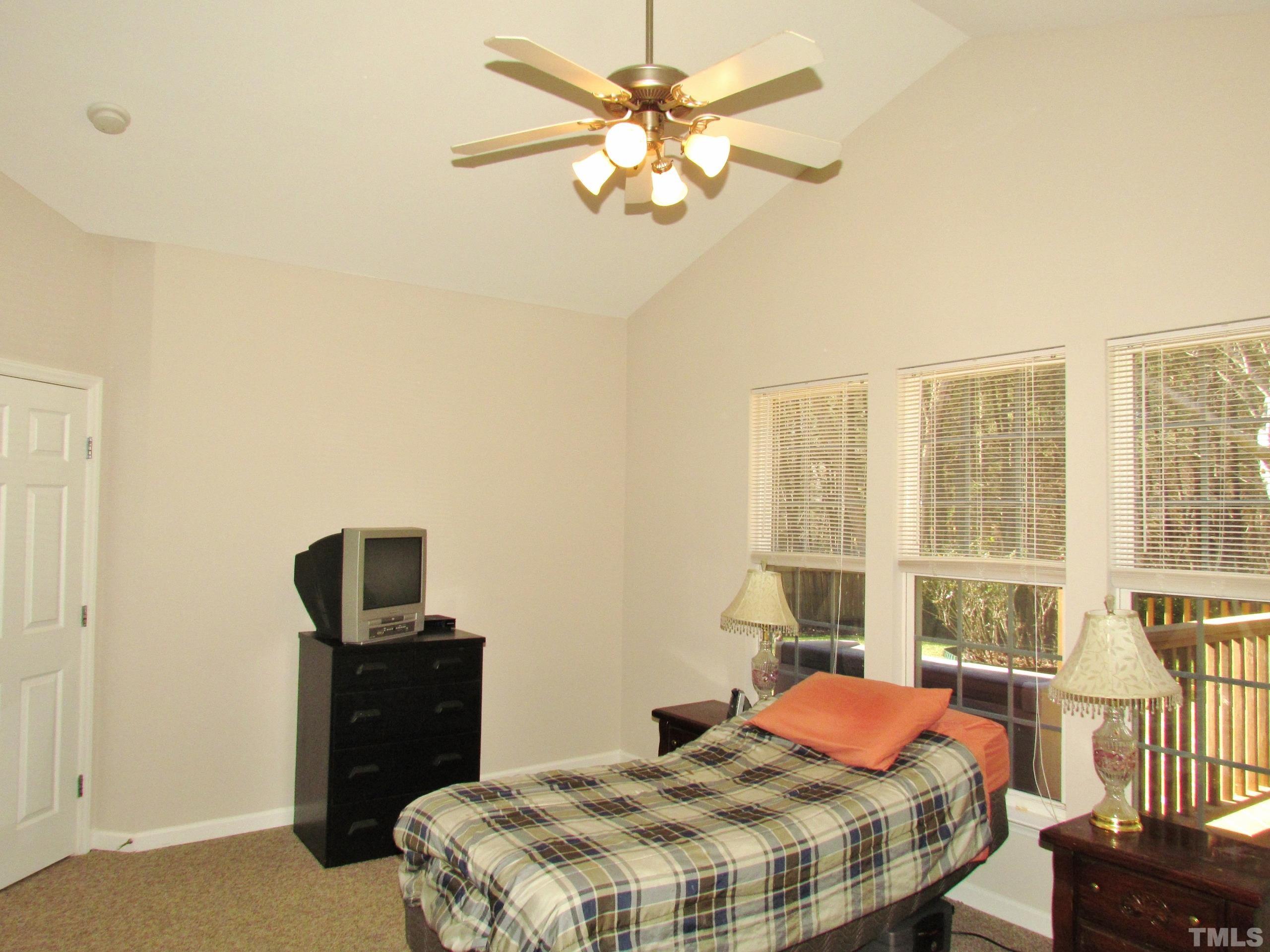 8421 Whisper Ridge Place Raleigh, NC 27613 - Photo 11 of 30 a bedroom with a bed dresser and a window