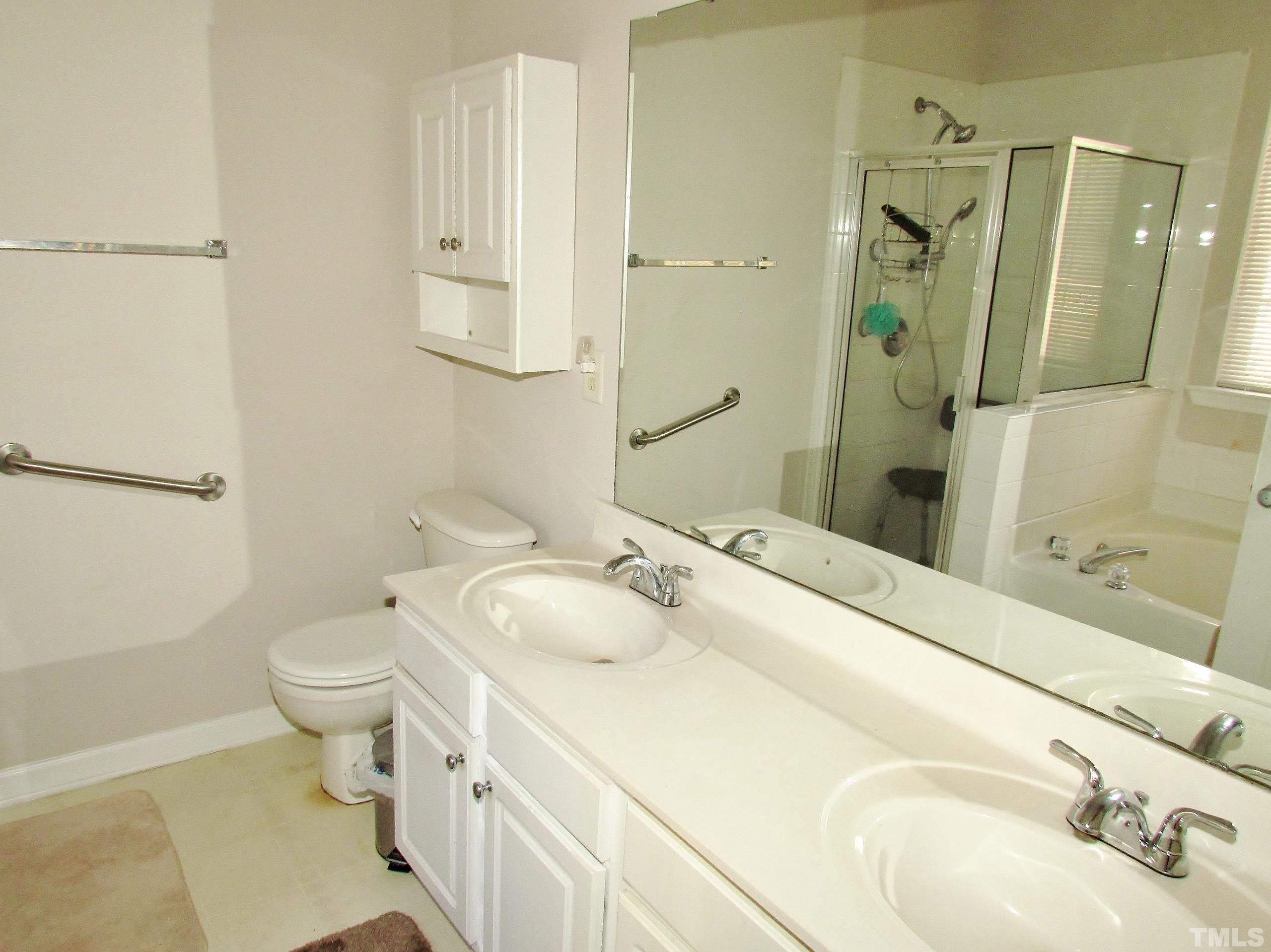 8421 Whisper Ridge Place Raleigh, NC 27613 - Photo 14 of 30 a bathroom with a sink toilet and shower
