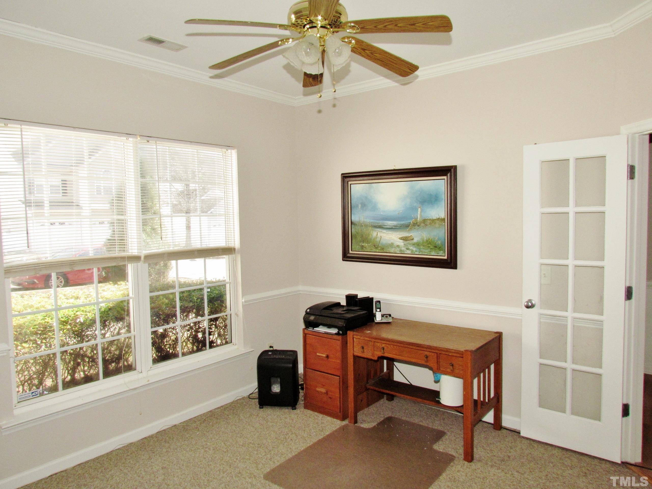 8421 Whisper Ridge Place Raleigh, NC 27613 - Photo 16 of 30 a living room with furniture a window and a ceiling fan