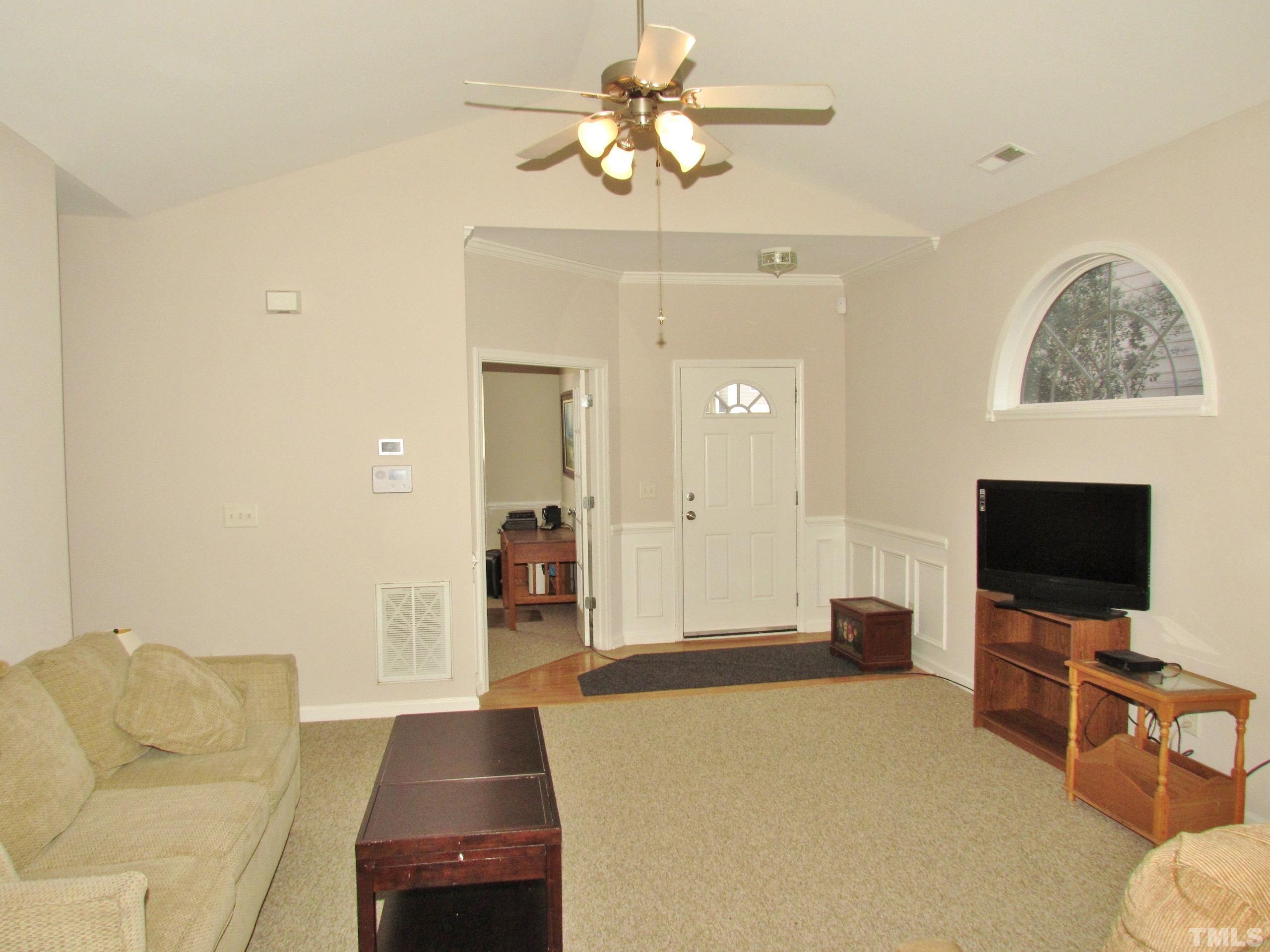 8421 Whisper Ridge Place Raleigh, NC 27613 - Photo 2 of 30 a bedroom with furniture and a flat screen tv