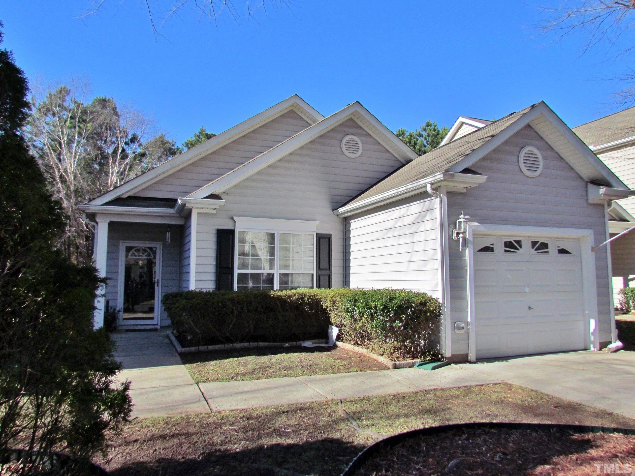 8421 Whisper Ridge Place Raleigh, NC 27613 - Photo 25 of 30 a front view of a house with a yard