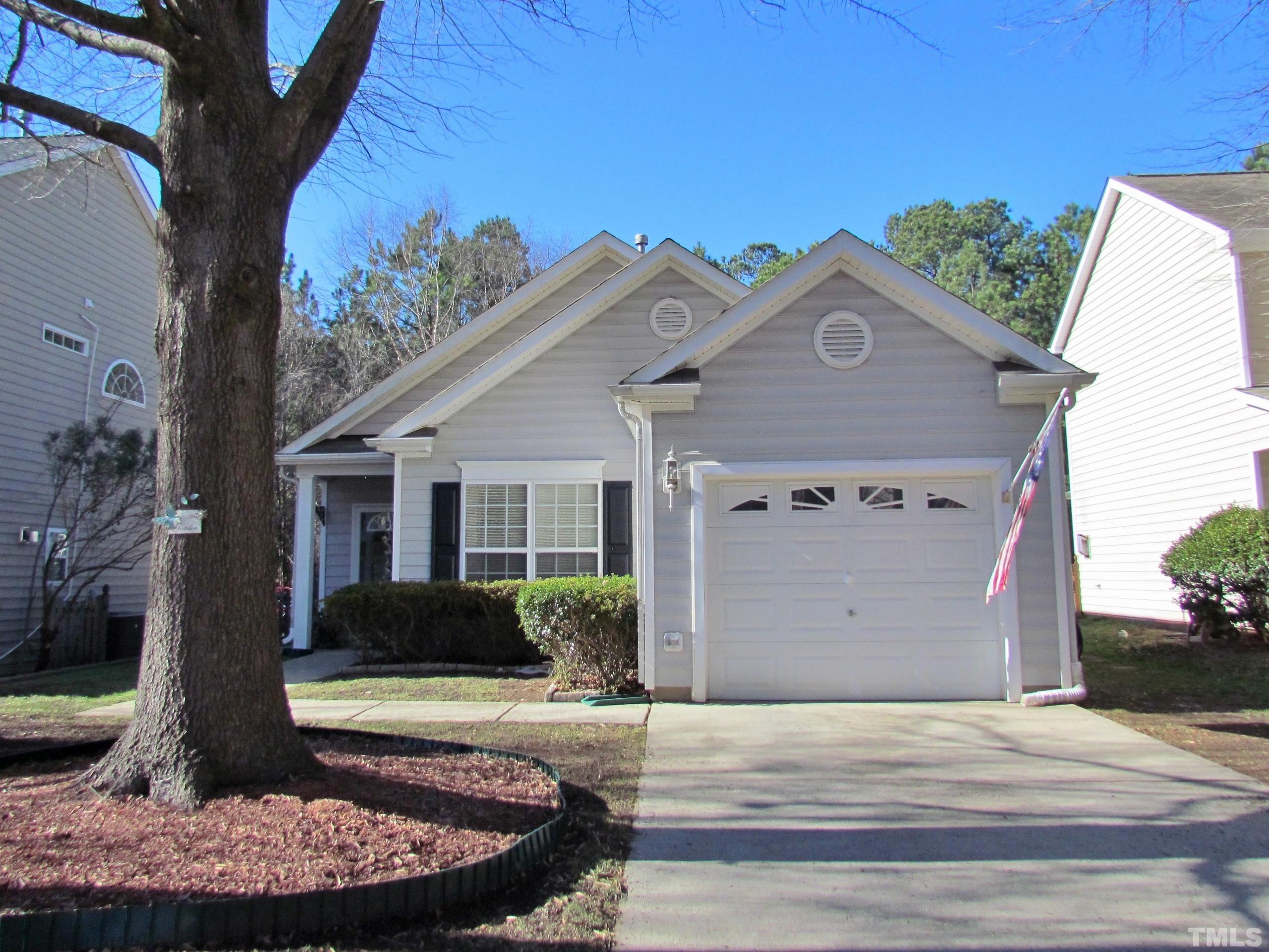 8421 Whisper Ridge Place Raleigh, NC 27613 - Photo 26 of 30 a view of a house with a yard potted plants and a table and chair