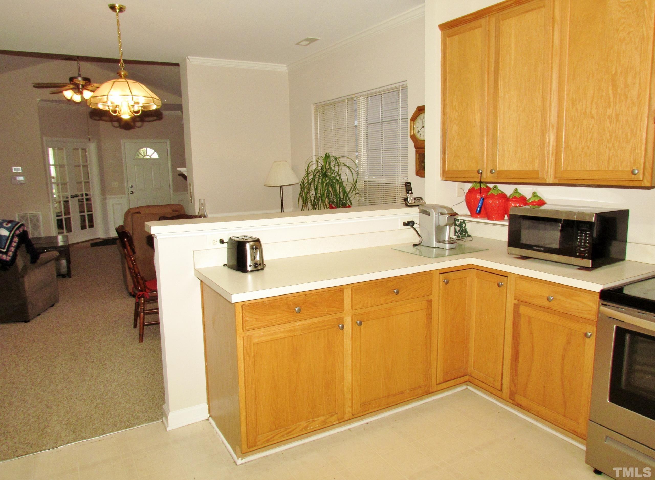 8421 Whisper Ridge Place Raleigh, NC 27613 - Photo 8 of 30 a kitchen with a sink and a refrigerator
