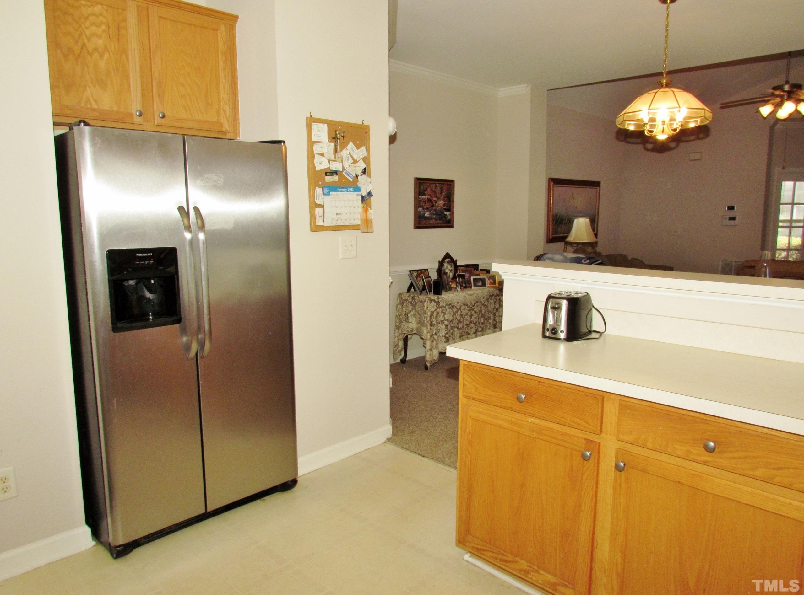 8421 Whisper Ridge Place Raleigh, NC 27613 - Photo 9 of 30 a kitchen with refrigerator and cabinets