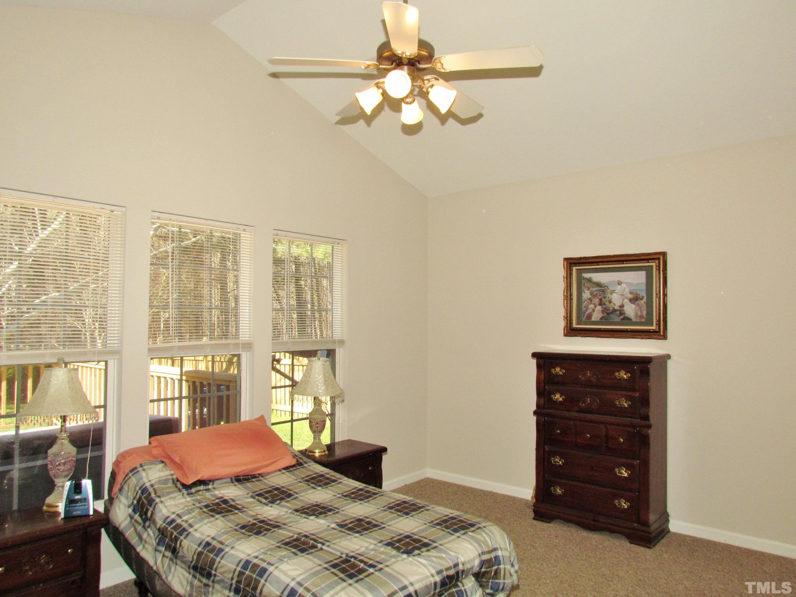 8421 Whisper Ridge Place Raleigh, NC 27613 - Photo 10 of 30 a bedroom with a bed dresser and a window