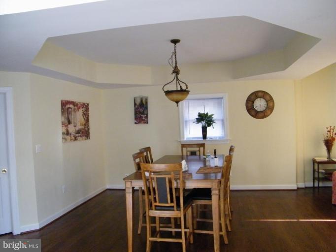 6013 Amherst Avenue Springfield, VA 22150 - Photo 3 of 11 a view of a dining room with furniture and wooden floor