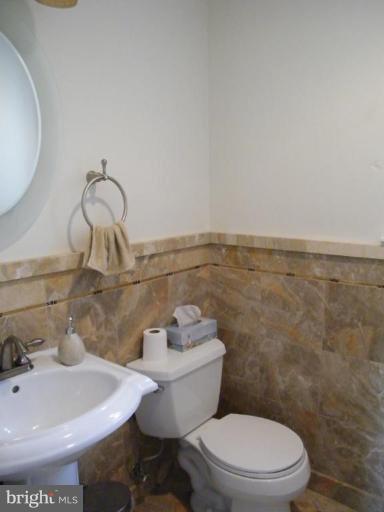 6013 Amherst Avenue Springfield, VA 22150 - Photo 6 of 11 a bathroom with a sink a toilet and a mirror