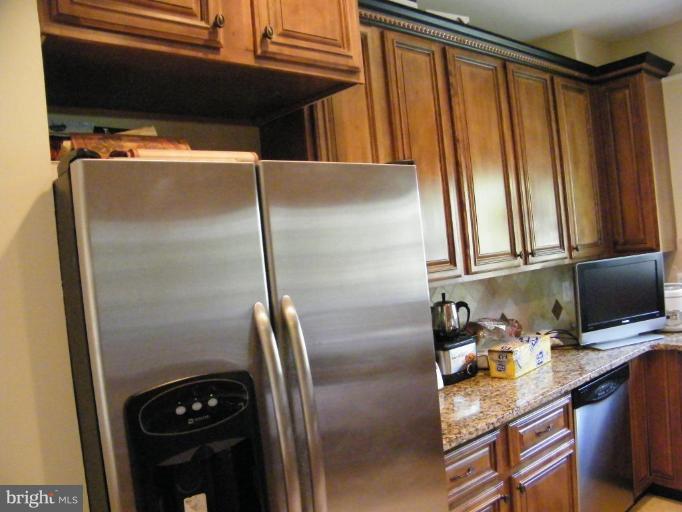 6013 Amherst Avenue Springfield, VA 22150 - Photo 10 of 11 a kitchen with a refrigerator and a window