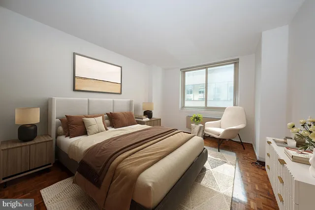 a bedroom with a bed couch and window