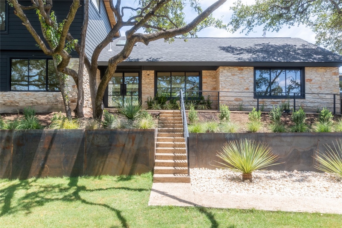 2107 Toro Canyon Road Austin, TX 78746 - Photo 1 of 1 a front view of a house with a garden