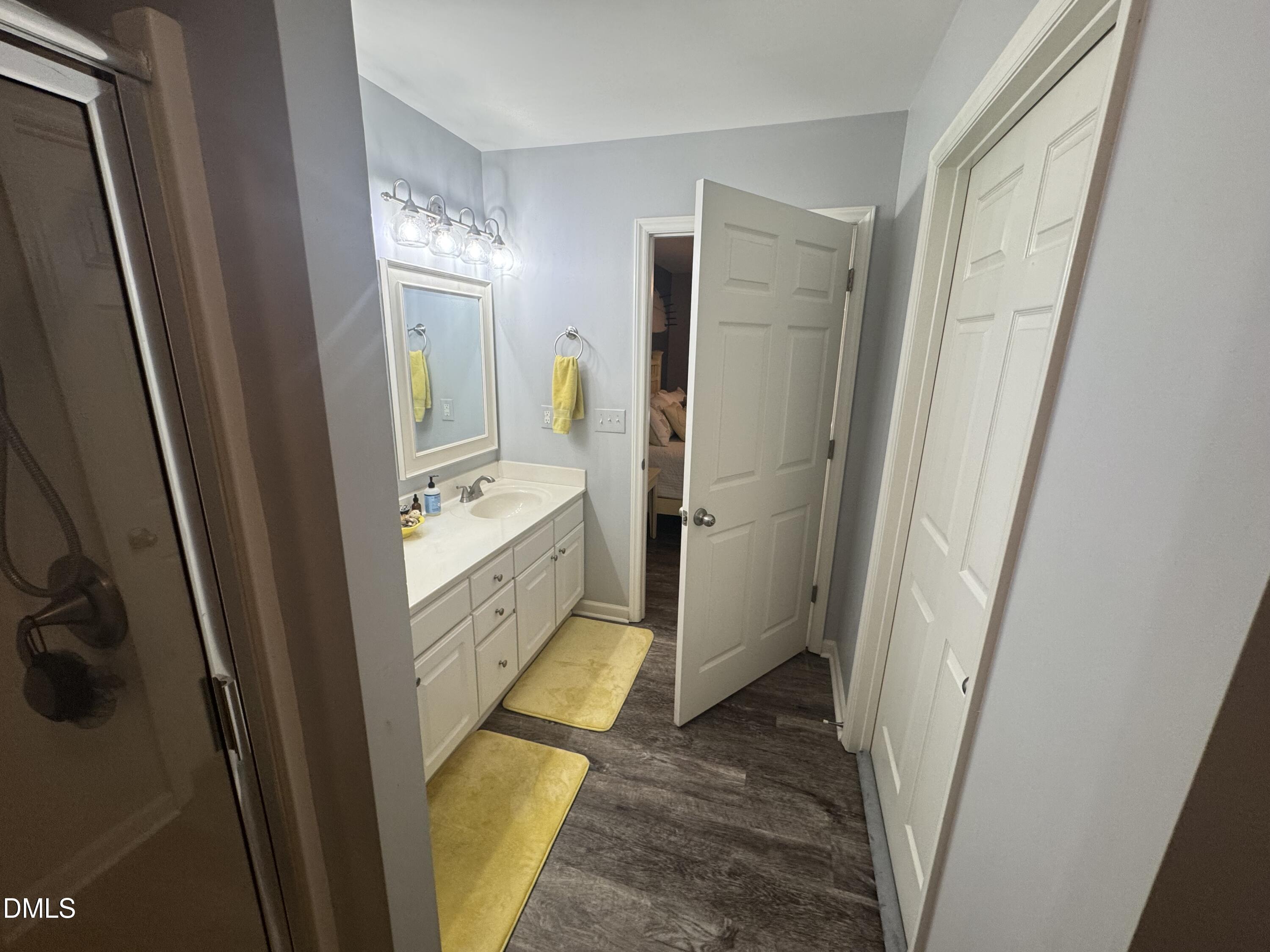 11351 Clubhaven Place, Unit 100 Raleigh, NC 27617 - Photo 21 of 29 a bathroom with a double vanity sink and a mirror
