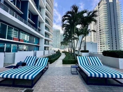 a view of balcony with wooden floor and outdoor seating