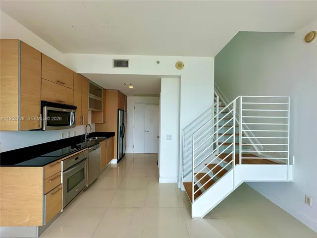 a kitchen with stainless steel appliances a stove and a refrigerator