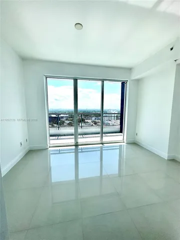 an empty room with large windows