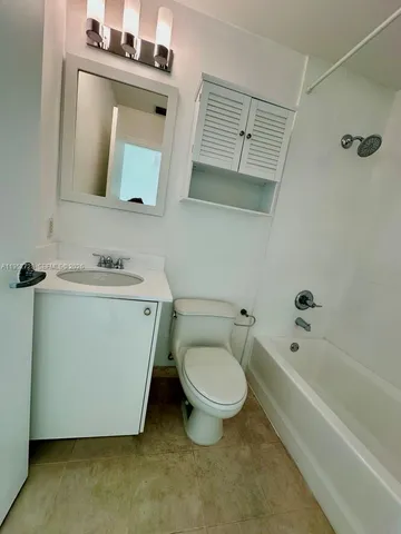 a bathroom with a sink a toilet and bathtub