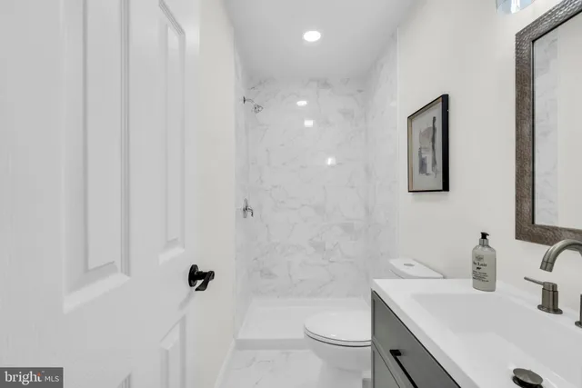 a kitchen with a table chairs a sink dishwasher and cabinets with wooden floor