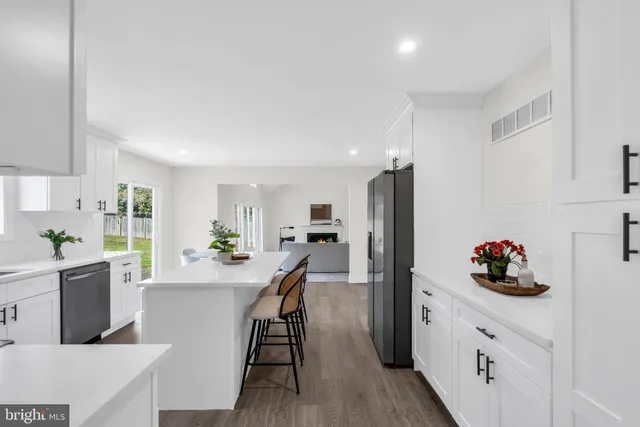 a living room with furniture a fireplace and a floor to ceiling window