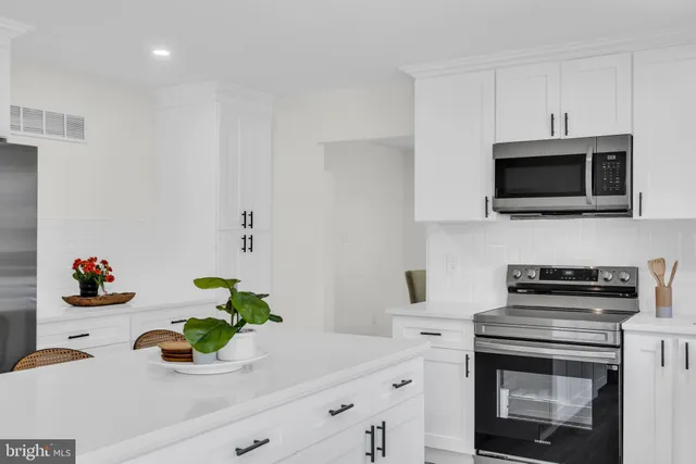 a living room with furniture a fireplace and a large window