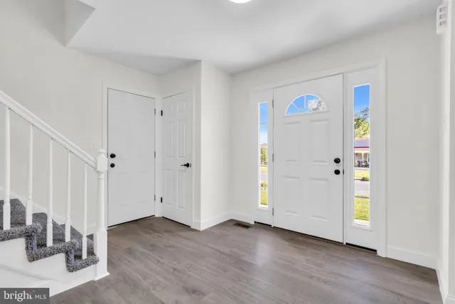 a view of a livingroom with furniture and stairs