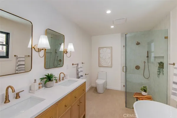 a bathroom with a granite countertop sink mirror toilet and shower