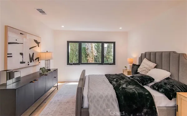 a bedroom with a large bed and a large window