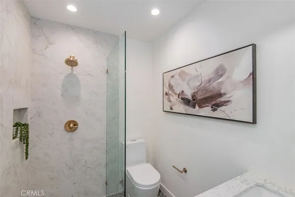 a bathroom with a picture on the wall and a shower
